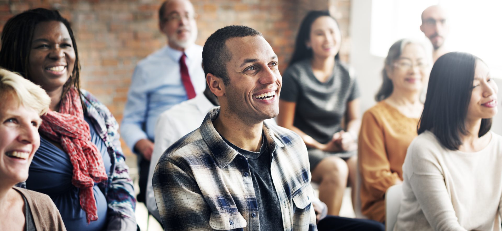 A group of people listening to a speaker.
